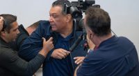 U.S. Sen. Alex Padilla of California is pushed out of the room after he interrupted Homeland Security Secretary Kristi Noem during a news conference in Los Angeles on June 12, 2025.