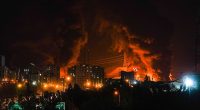 Fire and smoke rise into the sky after an Israeli attack on an oil depot in Tehran, Iran, at dawn on Sunday, June 15, 2025