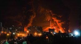 Fire and smoke rise into the sky after an Israeli attack on an oil depot in Tehran, Iran, at dawn on Sunday, June 15, 2025