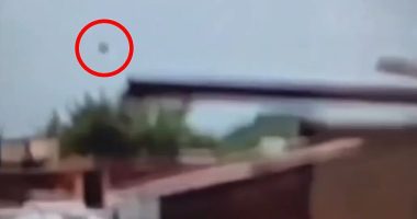 The mysterious piece of debris that flew off the plane into the air is circled here just as the London-bound Boeing 787-8 Dreamliner disappeared from view and crashed