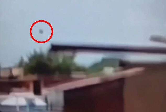 The mysterious piece of debris that flew off the plane into the air is circled here just as the London-bound Boeing 787-8 Dreamliner disappeared from view and crashed
