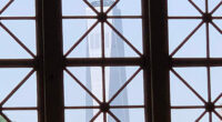 The Freedom Tower in Manhattan, seen through a window of the Great Hall on Ellis Island. (© Pierre Tristam)