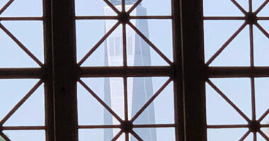 The Freedom Tower in Manhattan, seen through a window of the Great Hall on Ellis Island. (© Pierre Tristam)