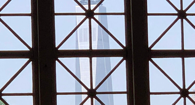 The Freedom Tower in Manhattan, seen through a window of the Great Hall on Ellis Island. (© Pierre Tristam)