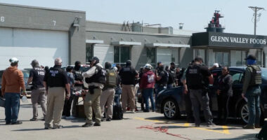 Federal immigration agents converge on Glenn Valley Foods in Omaha, Neb., on June 10 for an immigration raid. A new analysis released Thursday estimates mass deportations could cost more than 6 million jobs, a figure that includes both immigrants and U.S.-born workers. (Photo courtesy of U.S. Immigration and Customs Enforcement via Nebraska Examiner)