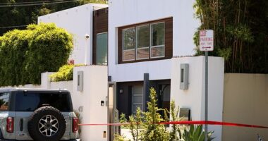 According to neighbors, a person, who may have been armed, was spotted hopping a fence on the tree-lined street in the ritzy California neighborhood