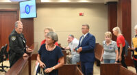 Palm Coast Mayor Mike Norris walking into court among supporters last week. Less than an hour later, he would walk out in defeat. (© FlaglerLive)