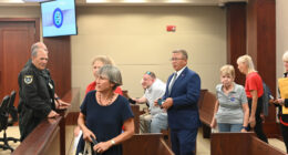 Palm Coast Mayor Mike Norris walking into court among supporters last week. Less than an hour later, he would walk out in defeat. (© FlaglerLive)