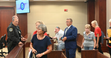 Palm Coast Mayor Mike Norris walking into court among supporters last week. Less than an hour later, he would walk out in defeat. (© FlaglerLive)