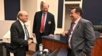 Thursday night trinity at the Flagler County Commission. From left, County Attorney Al Hadeed, who is retiring in a few days, Commissioner Greg Hansen, and newly chosen County Attorney Michael Rodriguez, moments after the commission