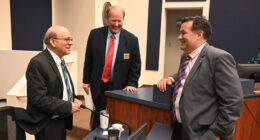 Thursday night trinity at the Flagler County Commission. From left, County Attorney Al Hadeed, who is retiring in a few days, Commissioner Greg Hansen, and newly chosen County Attorney Michael Rodriguez, moments after the commission