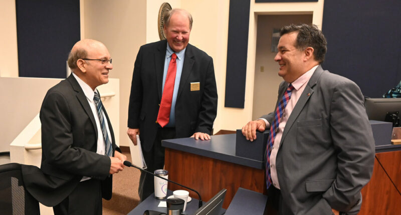 Thursday night trinity at the Flagler County Commission. From left, County Attorney Al Hadeed, who is retiring in a few days, Commissioner Greg Hansen, and newly chosen County Attorney Michael Rodriguez, moments after the commission