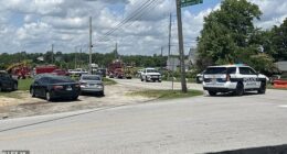 A state trooper has been seriously wounded in a shootout at a major airport before the gunman fled into a church (street outside pictured) during Sunday service