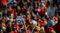 QAnon supporters wait for Donald Trump to speak at a campaign rally at Atlantic Aviation on September 22, 2020, in Moon Township, Pennsylvania.