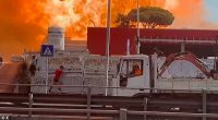 A civilian sprints away from a huge explosion at the petrol station