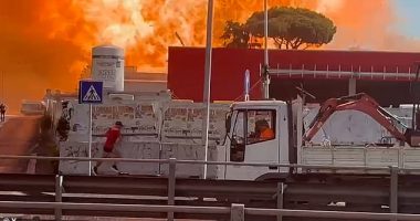 A civilian sprints away from a huge explosion at the petrol station