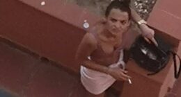 A woman accused of squatting in a property owned by Brits on the Costa del Sol glares as her picture is taken