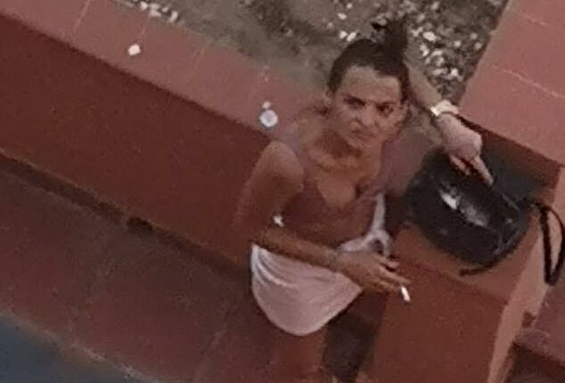 A woman accused of squatting in a property owned by Brits on the Costa del Sol glares as her picture is taken