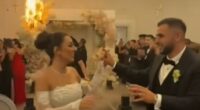 The couple's first dance quickly descended into chaos as indoor fireworks and pyrotechnics erupted near a floral archway and lit the pricey blooms on fire (pictured)