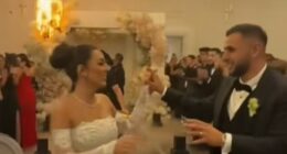 The couple's first dance quickly descended into chaos as indoor fireworks and pyrotechnics erupted near a floral archway and lit the pricey blooms on fire (pictured)