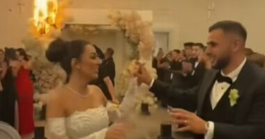 The couple's first dance quickly descended into chaos as indoor fireworks and pyrotechnics erupted near a floral archway and lit the pricey blooms on fire (pictured)