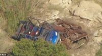 The ATV appears to have come to a stop on top of another vehicle. Hutchins' blue Polaris ATV is seen lying on top of a rusty vehicle, which also appeared to have gone over the cliff