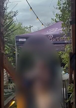 An unidentified woman is recorded by diners at Toorak Cellars in Armadale
