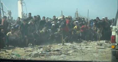 As the cars approach the swarming crowds of Gazans, successive rounds of gunshots can be heard as they land and lift dust just inches away from the crowds
