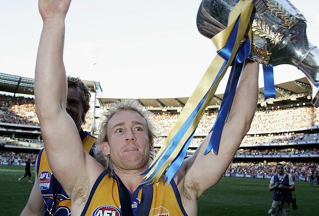 Michael Braun of the Eagles celebrates with the trophy after the AFL Grand Final in 2006