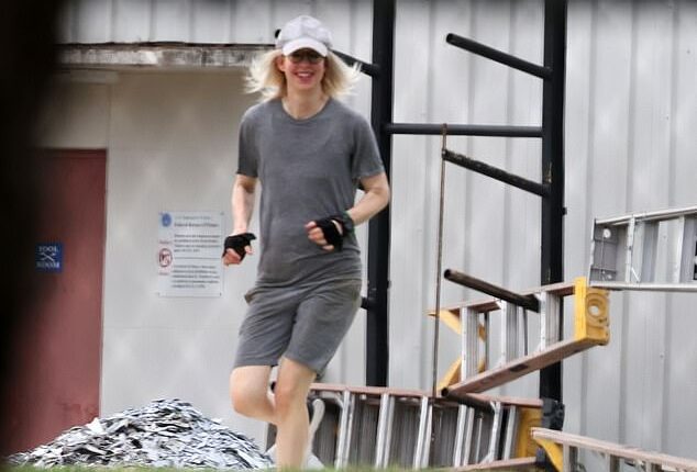 All smiles: Elizabeth Holmes flashed a smile as she was seen working out Saturday at Federal Prison Camp Bryan, the minimum-security facility Ghislaine Maxwell was transferred to