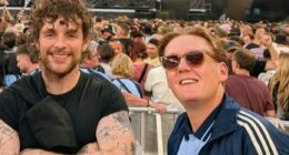 Brit actor looks unrecognisable from his famous childhood role as he watches Oasis with Tom Grennan