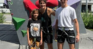 Trudeau ditches the suit for a sleeveless tank as he poses with sons Xavier and Hadrien at a climbing gym during their Canadian road trip