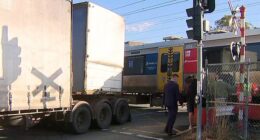 A semi-trailer crashed into a train at a level crossing just before 7am on Thursday